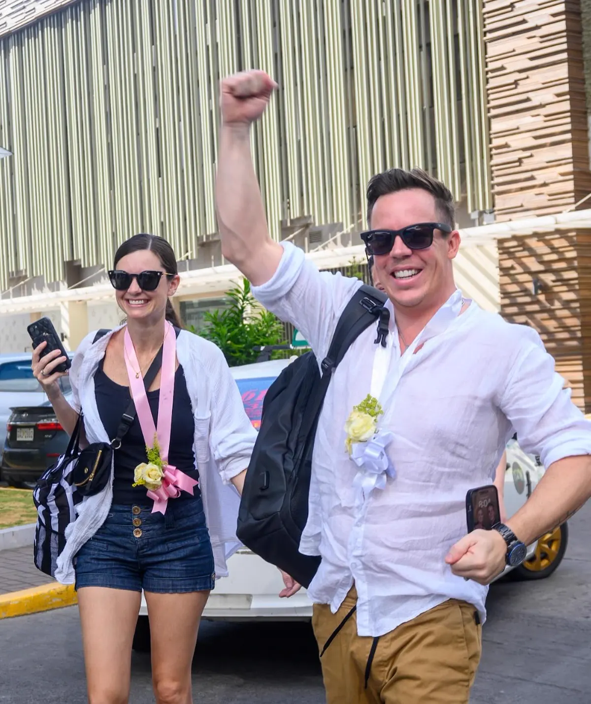 Two visitors celebrating their welcome outside the Oakridge building