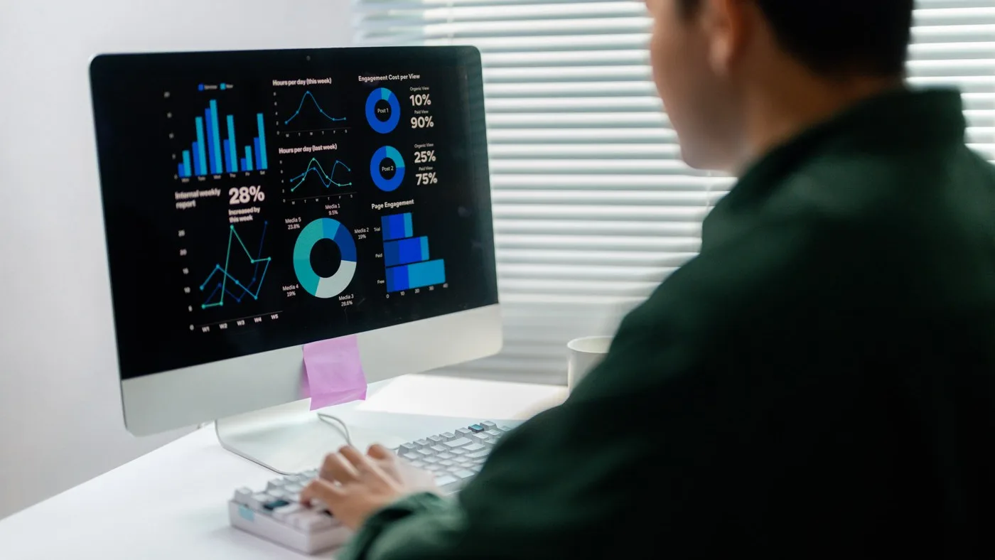 A marketer reviewing a dashboard of campaign performance charts